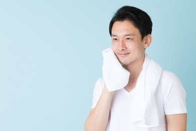 portrait of young asian man isolated on blue background