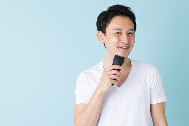 portrait of young asian man isolated on blue background