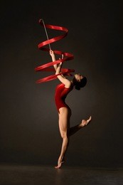rhythmic gymnast in red leotard with ribbon