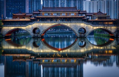 anshun bridge in chengdu, sichuan, turns on its lights for the evening. crossing the jin river the bridge now hosts an upscale bar and a tribute to marco polo who mentioned the bridge in his writings.