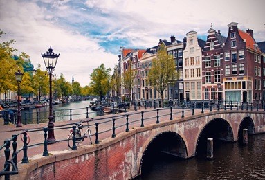 beautiful view of amsterdam canals with bridge and typical dutch houses. holland