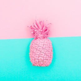 painted pink pineapple on double turquoise background. fashion minimal and surrealism concept of food for summer