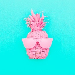 painted pink pineapple in sunglasses on the background of turquoise. minimalism and creative conceptual surrealism