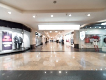 shopping mall blur background with bokeh. blurred hall of shopping mall with customers as background. copy space