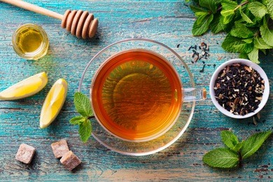 tea cup with mint leaf. wooden background. top view.