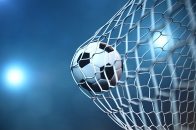 3d rendering soccer ball in goal. soccer ball in net with spotlight or stadium light background, success concept