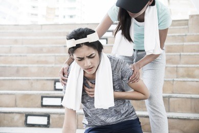 sport women is clutching her chest, acute pain possible heart attack.