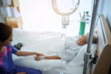 abstract medical drip in the hospital room of patients in the bed blur background, intensive therapy concept