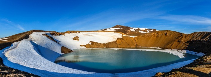 viti volcanic crater lake green surface with snow and blue sky panorama, myvatn lake surroundings, north iceland