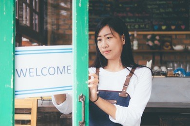 open small business: happy owner of a cafe. young startup owner small cafe shop