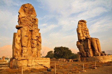 the ancient colossi of memnon, two massive stone statues of pharaoh amenhotep iii near luxor, egypt.