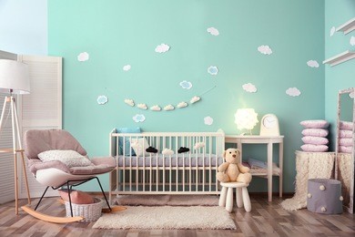 modern baby room interior with crib and rocking chair