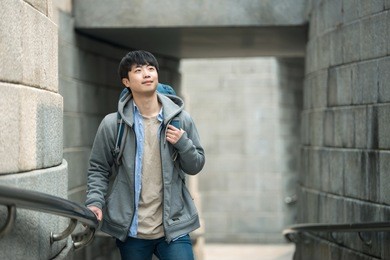 a young man doing a backpacking trip in a korean traditional house.