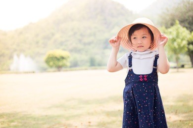 uv protection in baby , asian baby walk and play in nature background , vintage style , she feel happy in family time