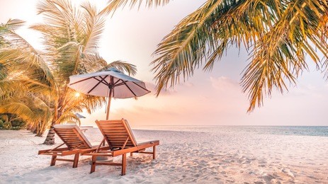 beautiful sunset beach scene. chairs on the sandy beach near the sea. summer holiday and vacation concept for tourism. inspirational tropical landscape


