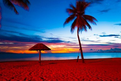 enjoying red and orange sunset at a beach in denarau island, fiji