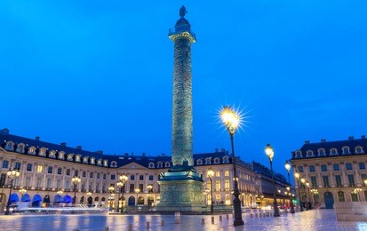 vendome column with statue of napoleon bonaparte, on the place vendome at night, in france. vendome column has 425 spiraling bas-relief bronze plates were made out of cannon.