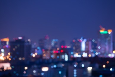 abstract urban city night light bokeh defocused background with sky space area