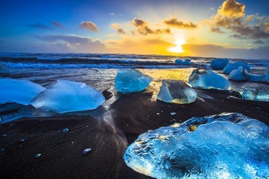 ice rock with black sand beach at jokulsarlon beach (diamond beach) in southeast iceland