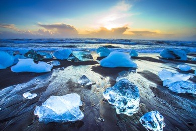 ice rock with black sand beach at jokulsarlon beach (diamond beach) in southeast iceland