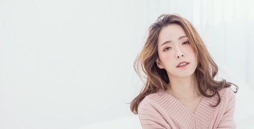 portrait of young beautiful asian woman relax in her bedroom. smile happy asian teenage girl isolated on white background banner.