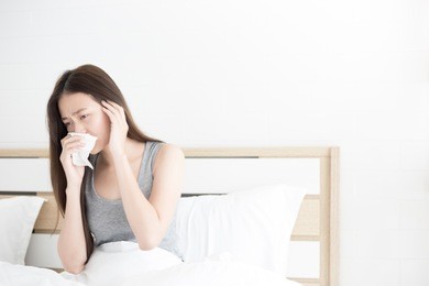 asian female patient stay on white bed, influenza virus, she cough and sneeze , headache