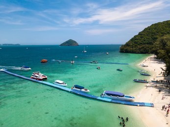 aerial of cabin cruiser and speedboath on the big ocean in andaman at koh he or coral island, phuket, thailand