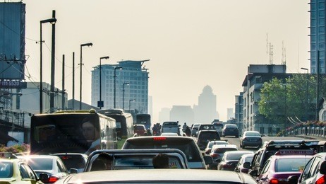 bangkok rush hour haevy trafic jam in the morning, buildings in mist as background.