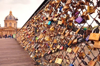 closeup of the symbolic colourful padlocks on pont des arts bridge, paris, france