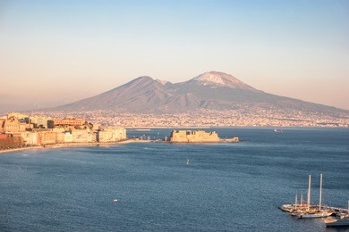 panoramic view of the famous gulf of naples, with the vesuvius on background at sunset