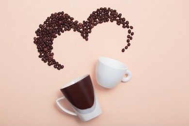 two cups with coffee beans on light background