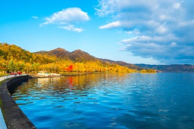 lake toya in toyako town, hokkaido, japan.  lake toya in beautiful morning with cloudy blue sky and mountain background. 