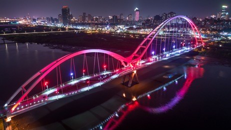 crescent bridge - famous landmark of new taipei, taiwan with beautiful illumination at night, aerial photography in new taipei, taiwan.