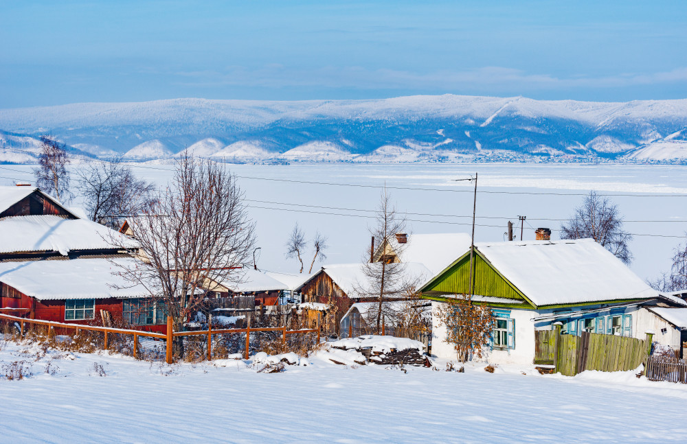 winter morning view of the village houses by baikal lake. sludanka. russia.