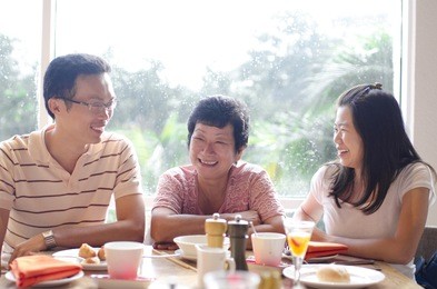 asian young adults and senior having good time in restaurant