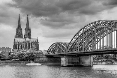 panoramic view of cologne cathedral and hohenzollern bridge, cologne, germany. black and white photo with infrared filter.