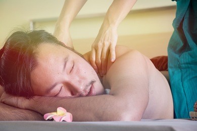 man is having thai massage at shoulder