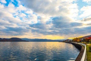 lake toya in toyako town, hokkaido, japan.  lake toya in beautiful morning with cloudy blue sky and mountain background. 