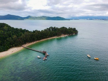 aerial view of manukan island jetty in sabah, malaysia with beautiful green ocean.