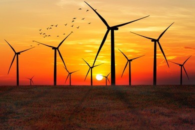 silhouette of wind turbines at sunset. the concept of alternative energy.