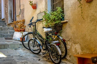 a pair of bicycles locked together on a picturesque narrow alley in monterosso al mare, cinque terre italy
