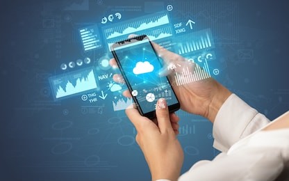 female hand using smartphone with financial tracking concept illustrated by graphs and symbols