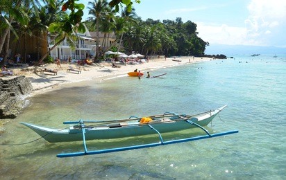 tropical sandy beach, moored boat on the beach, people enjoy the sea and the sun on the island of boracay, philippines, diniwid beach 