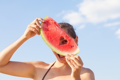 young girl with watermelon on the beach