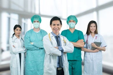 asian medical team surgeon and doctor standing smiling and arms crossed on hospital background include clipping path 