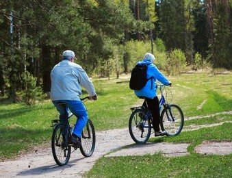active senior couple riding bikes in nature