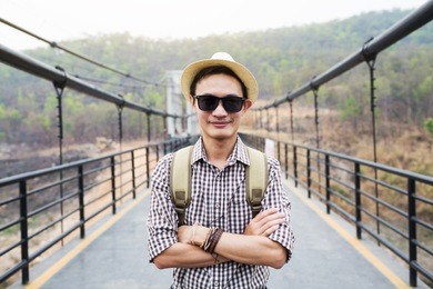 alone man traveller on mae kuang suspension bridge in summer nature outdoor, chiangmai in thailand.