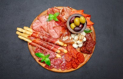 meat and cheese plate with salami sausage, chorizo, parma and mozzarella