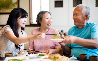 daughter and senior parent enjoy dinner in restaurant