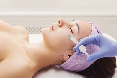 woman gets beauty facial injections. anti-aging, nourishing, vitamins treatment at spa salon. aesthetic cosmetology
